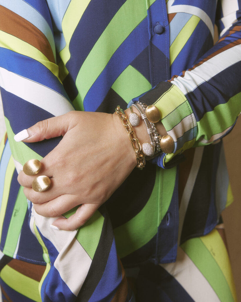 close-up of italian gold jewelry against vibrant summer dress