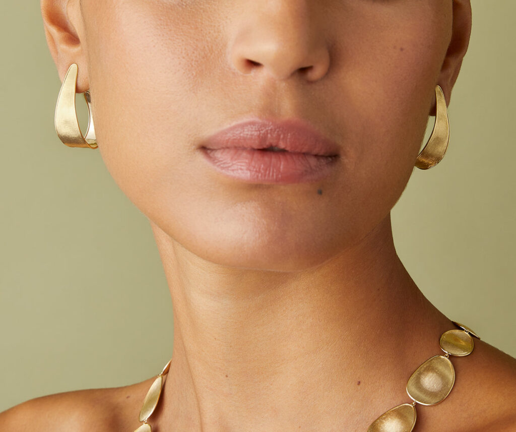 woman wearing hoop type of earrings