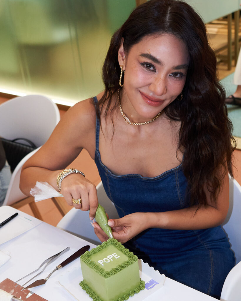 scintilla club member decorating a cake with FOPE in the middle