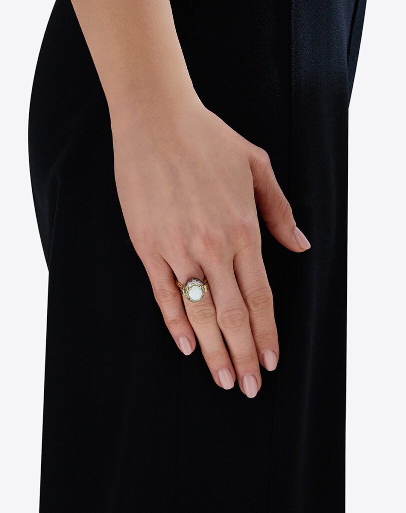 woman wearing nanis opal ring on her ring finger